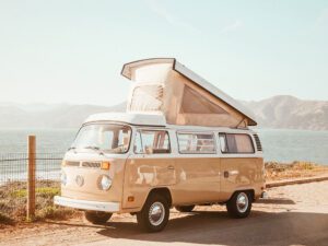 an old vw bus with pop up camper living the vanlife