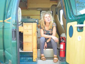 a girl brushing her teeth living the vanlife
